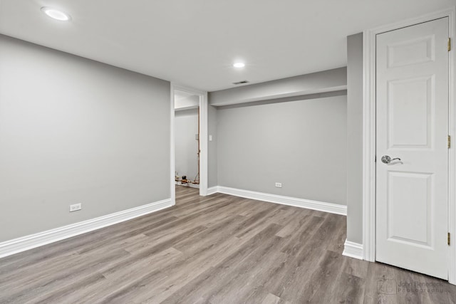 finished below grade area with recessed lighting, wood finished floors, visible vents, and baseboards