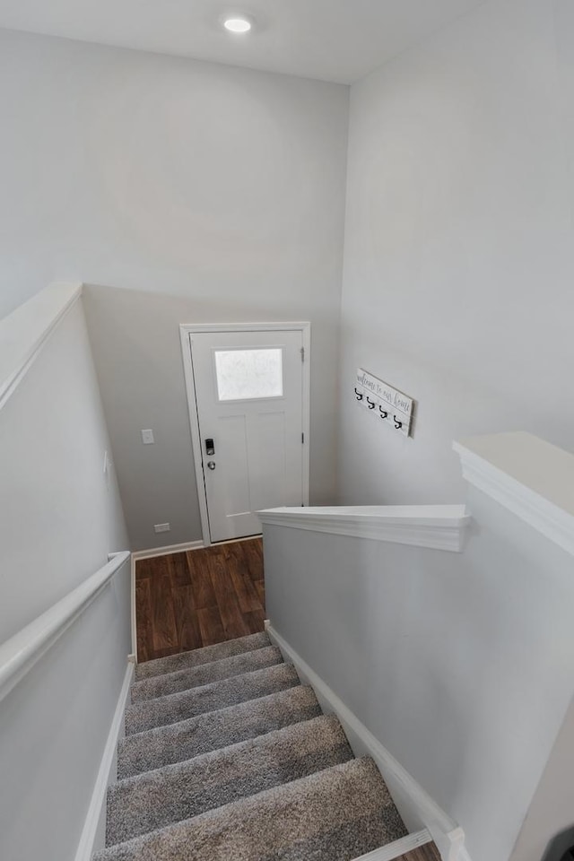 stairway featuring baseboards and wood finished floors