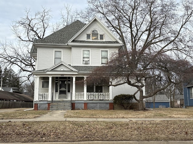 view of front of property featuring a porch and a shingled roof