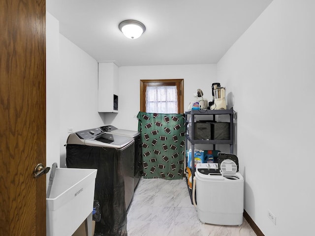 laundry area with independent washer and dryer, marble finish floor, a sink, and baseboards