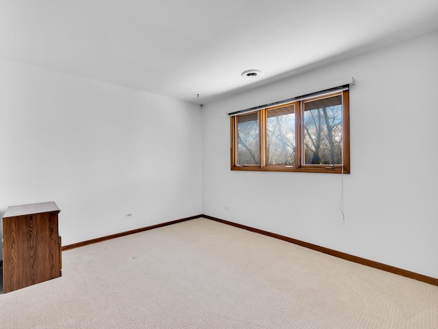 carpeted empty room with visible vents and baseboards