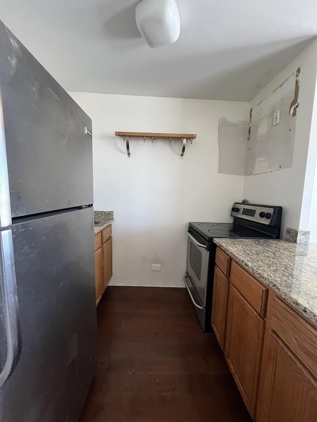 kitchen featuring light stone counters, stainless steel appliances, dark wood-style flooring, open shelves, and brown cabinetry