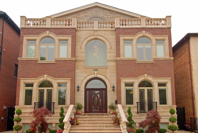 view of front of home with brick siding and french doors