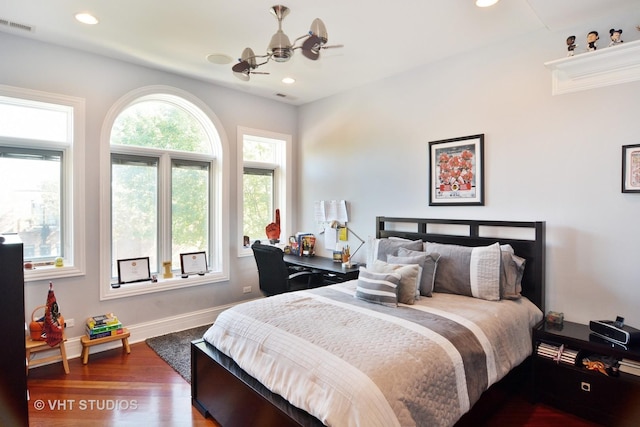 bedroom featuring recessed lighting, visible vents, baseboards, and wood finished floors