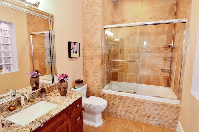 bathroom featuring vanity, toilet, tile patterned flooring, and tiled shower / bath combo