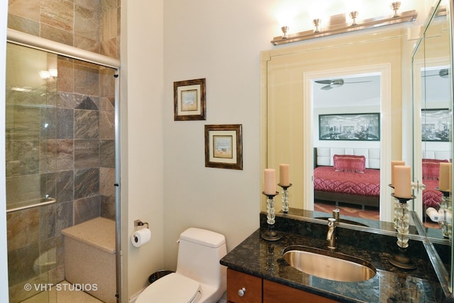 full bathroom with vanity, toilet, a stall shower, and ensuite bathroom