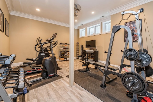 workout room with visible vents, crown molding, baseboards, and wood finished floors