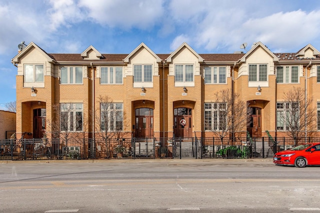 multi unit property with brick siding and fence private yard