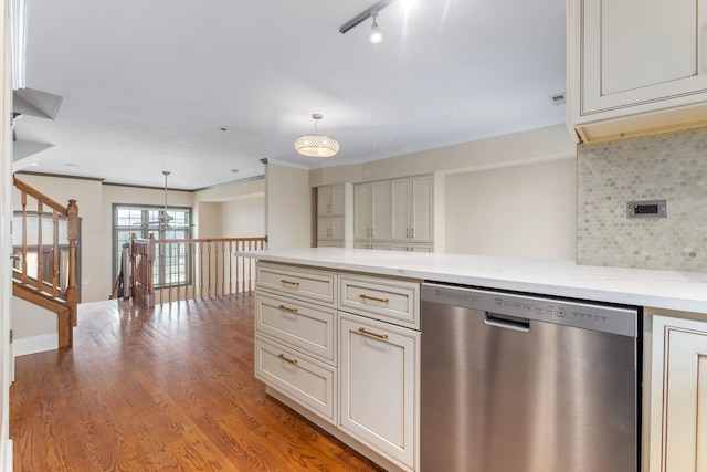 kitchen with wood finished floors, backsplash, dishwasher, and decorative light fixtures