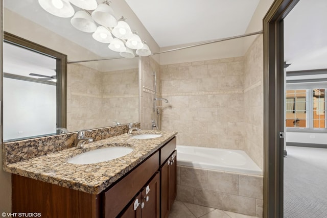 full bathroom with tiled shower / bath, double vanity, and a sink