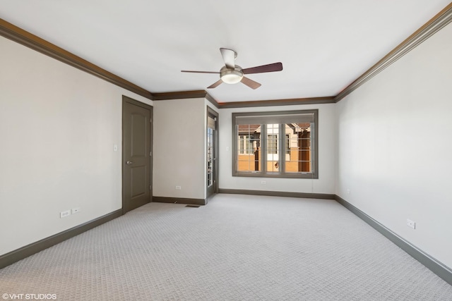 unfurnished room with crown molding, baseboards, a ceiling fan, and light colored carpet