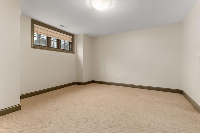 empty room with light carpet, visible vents, and baseboards