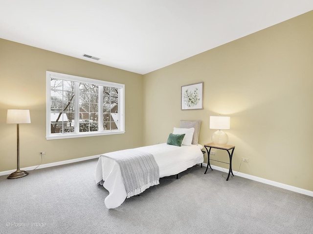 bedroom with carpet, visible vents, and baseboards