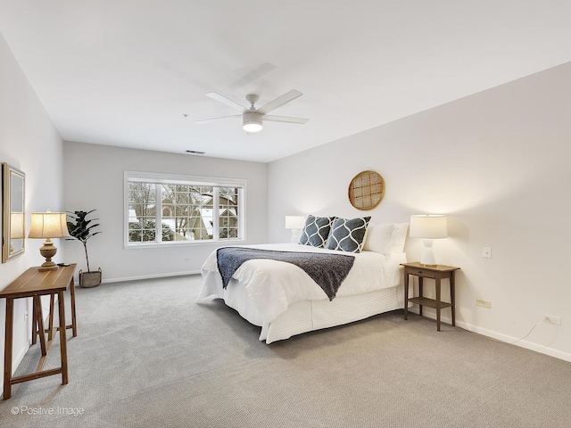 carpeted bedroom featuring ceiling fan and baseboards