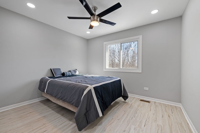 bedroom featuring light wood-type flooring, visible vents, baseboards, and recessed lighting