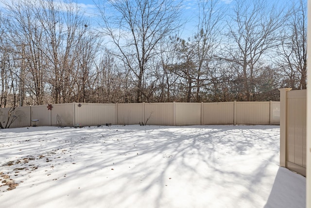 snowy yard with fence