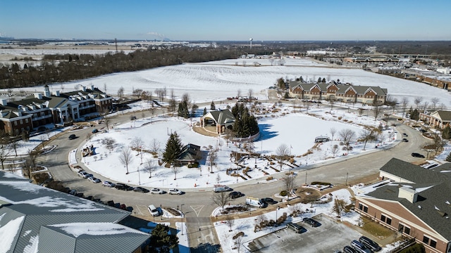 snowy aerial view with a residential view