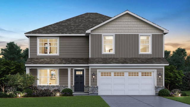 craftsman-style house featuring a shingled roof, stone siding, and driveway