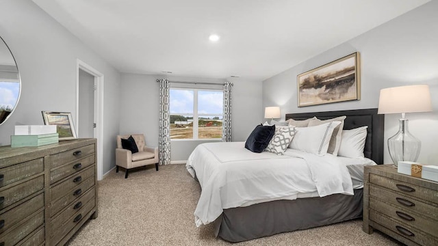 bedroom featuring light colored carpet and baseboards