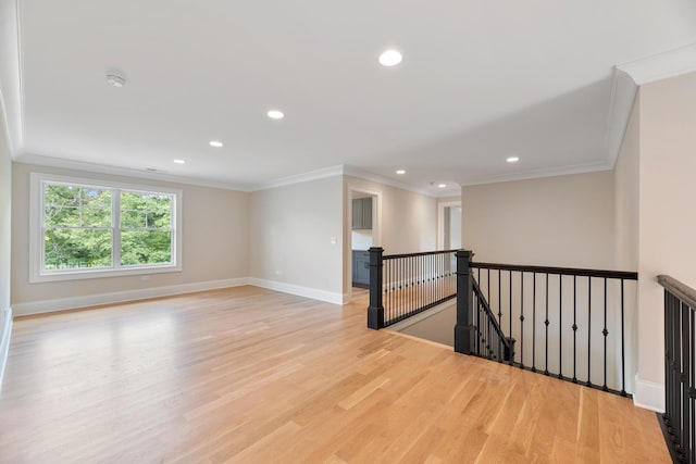 spare room featuring light wood-type flooring, baseboards, ornamental molding, and recessed lighting