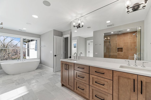 bathroom with double vanity, a stall shower, visible vents, and a sink