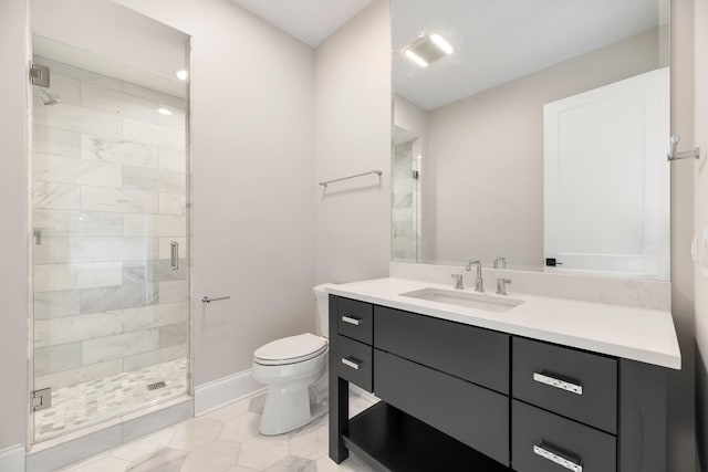 bathroom with a stall shower, vanity, toilet, and baseboards