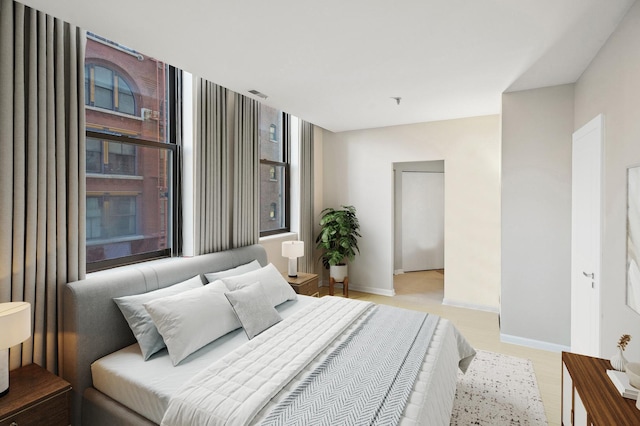 bedroom featuring visible vents and baseboards