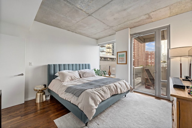 bedroom featuring dark wood-type flooring and access to exterior