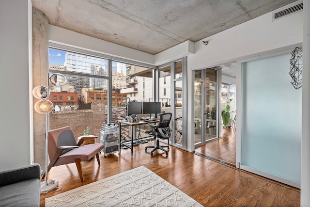 office space with wood finished floors and visible vents