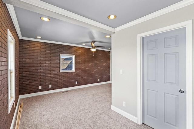 spare room with brick wall, a ceiling fan, baseboards, ornamental molding, and carpet