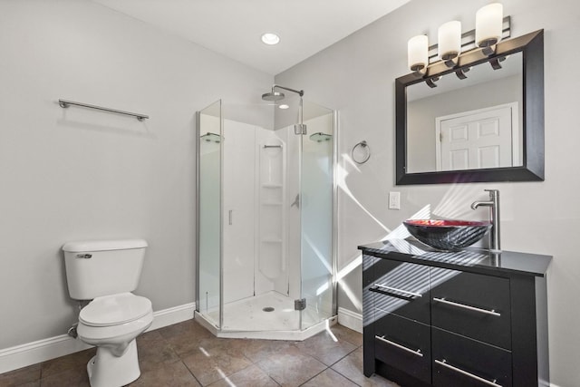 bathroom with baseboards, a shower stall, toilet, and tile patterned floors