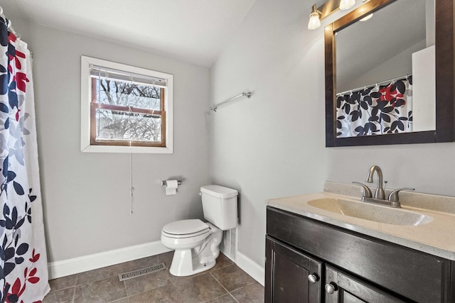 bathroom with lofted ceiling, visible vents, toilet, vanity, and baseboards