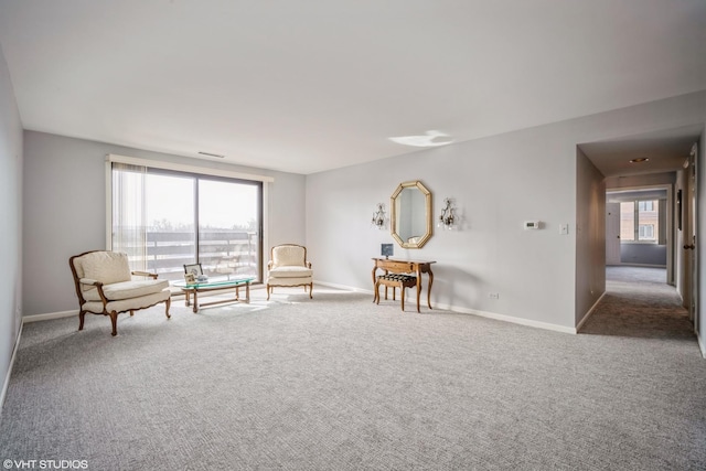 sitting room with carpet floors, a healthy amount of sunlight, and baseboards