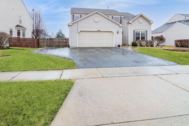 traditional home with a garage, a front yard, driveway, and fence