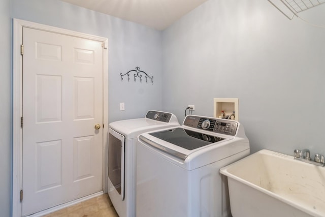 washroom featuring laundry area, a sink, and washer and dryer