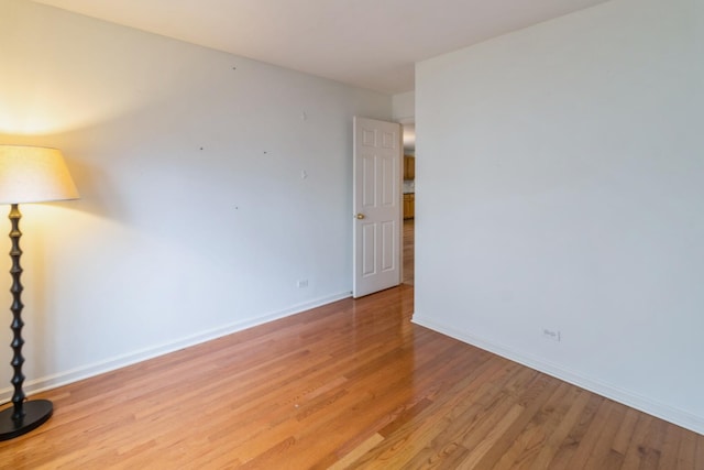 spare room with light wood finished floors and baseboards