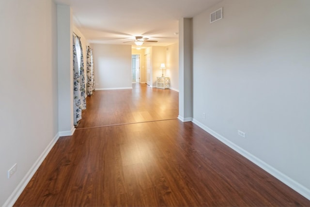 corridor with visible vents, baseboards, and wood finished floors