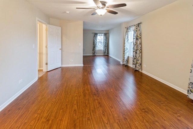 spare room with a ceiling fan, baseboards, and wood finished floors