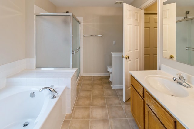 bathroom featuring toilet, tile patterned floors, vanity, a shower stall, and a bath