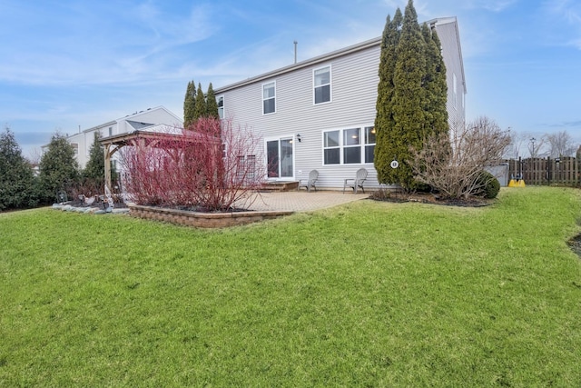 rear view of property featuring a patio area, fence, a lawn, and a gazebo