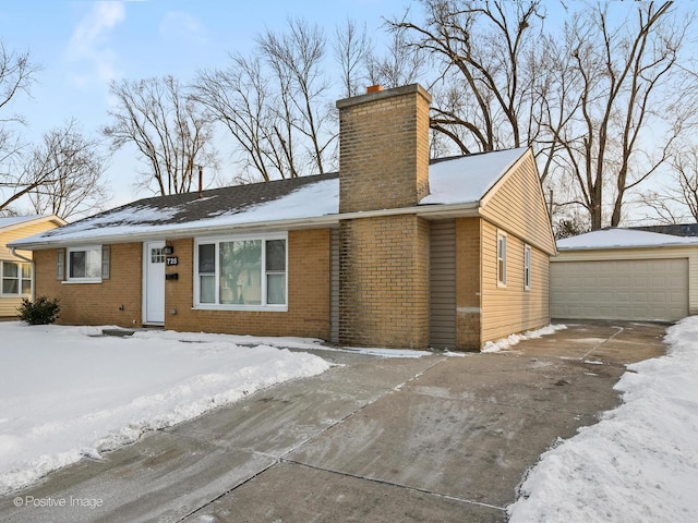 ranch-style house with a chimney, an outdoor structure, a detached garage, and brick siding