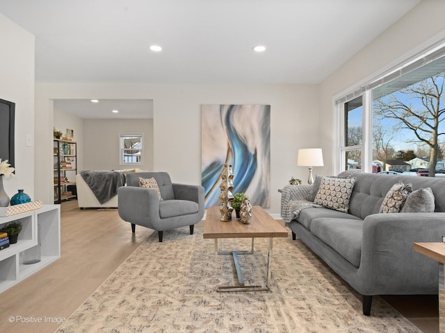 living room with plenty of natural light, light wood-type flooring, and recessed lighting