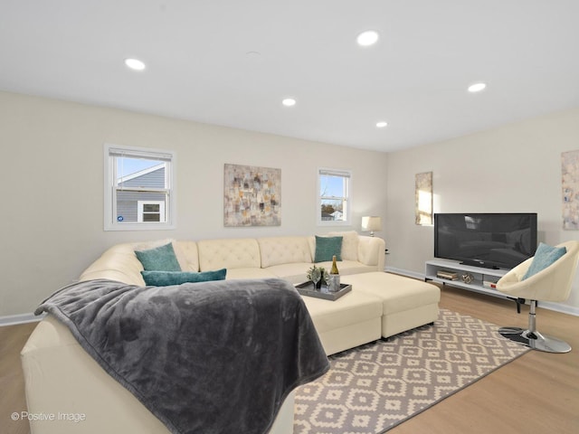 living room with baseboards, wood finished floors, and recessed lighting