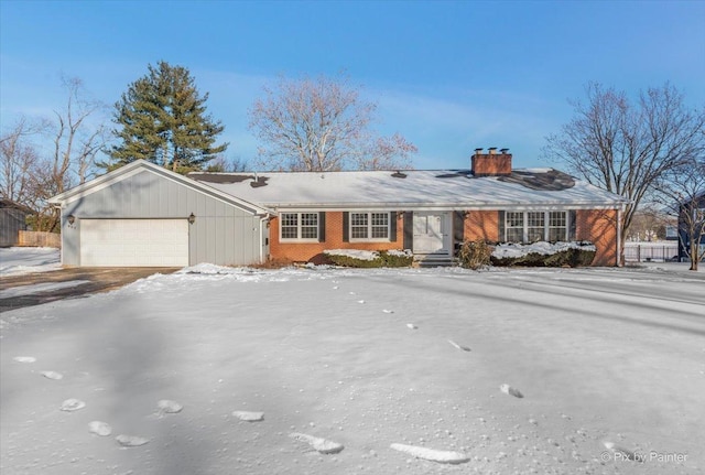 ranch-style house with a garage, brick siding, and a chimney