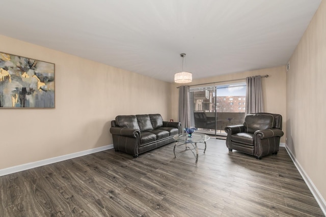 living area featuring dark wood-style floors and baseboards