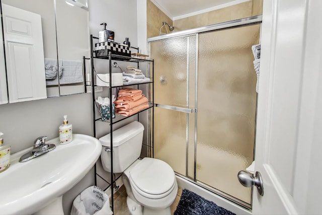 full bath with toilet, a shower stall, and a sink