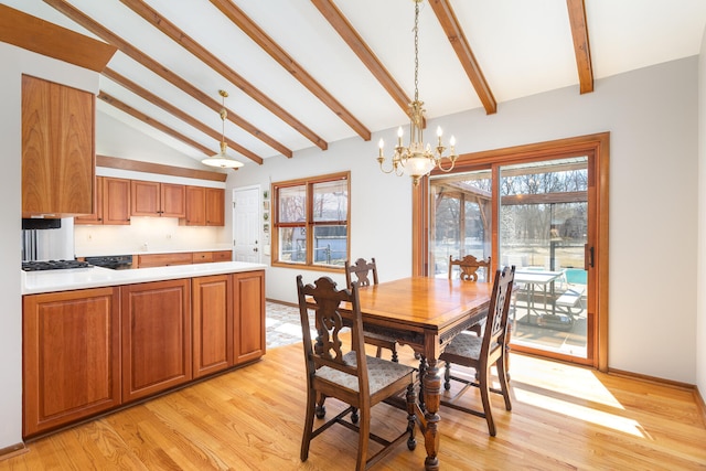 dining area featuring light wood finished floors, beamed ceiling, a chandelier, and baseboards