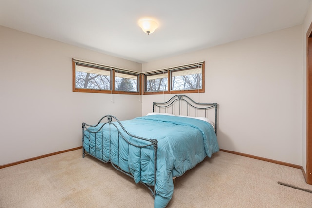 bedroom featuring visible vents, baseboards, and carpet