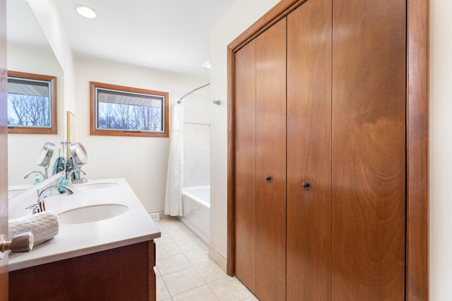 bathroom featuring a sink, shower / bath combination with curtain, double vanity, and tile patterned flooring