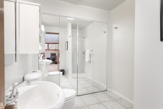 bathroom with toilet, a bidet, a stall shower, tile patterned floors, and a sink